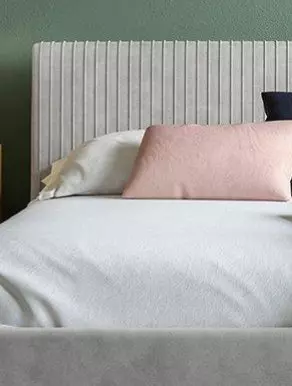 Grey bedframe in a bedroom setting